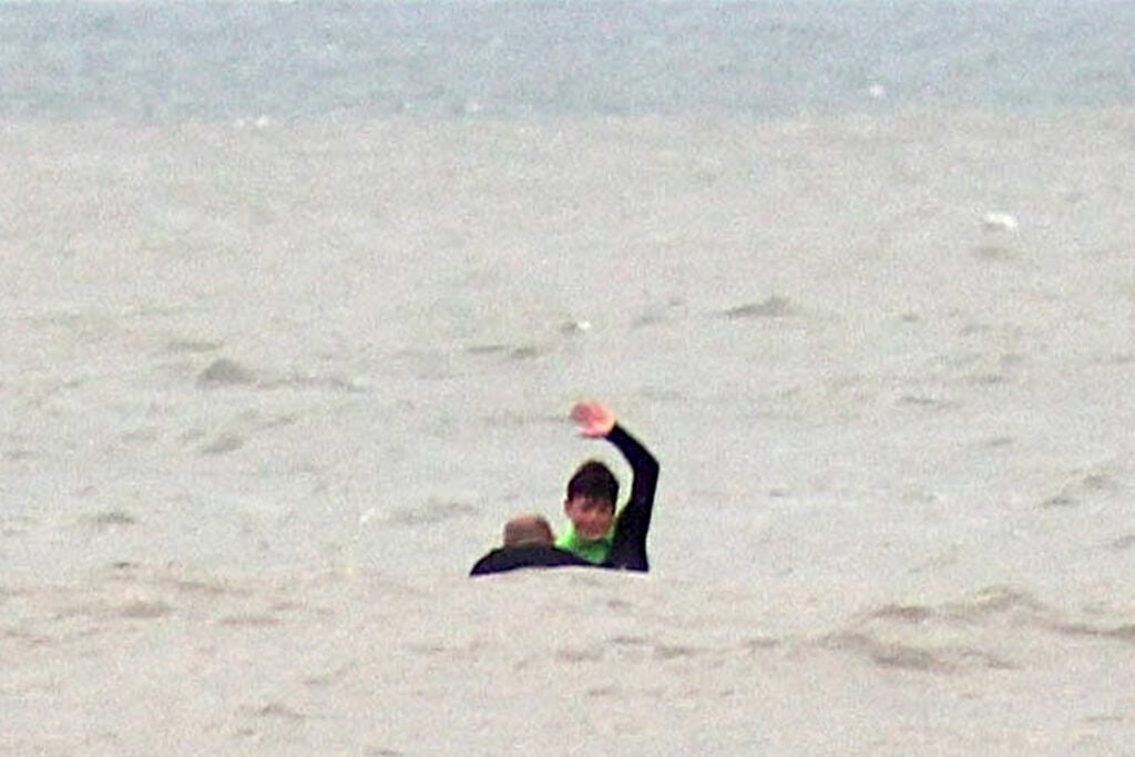 After stabilizing Gavin outside the surf zone, Oscar signaled ‘surfer in distress’ to his father on shore. | Photo: Neil Phillips