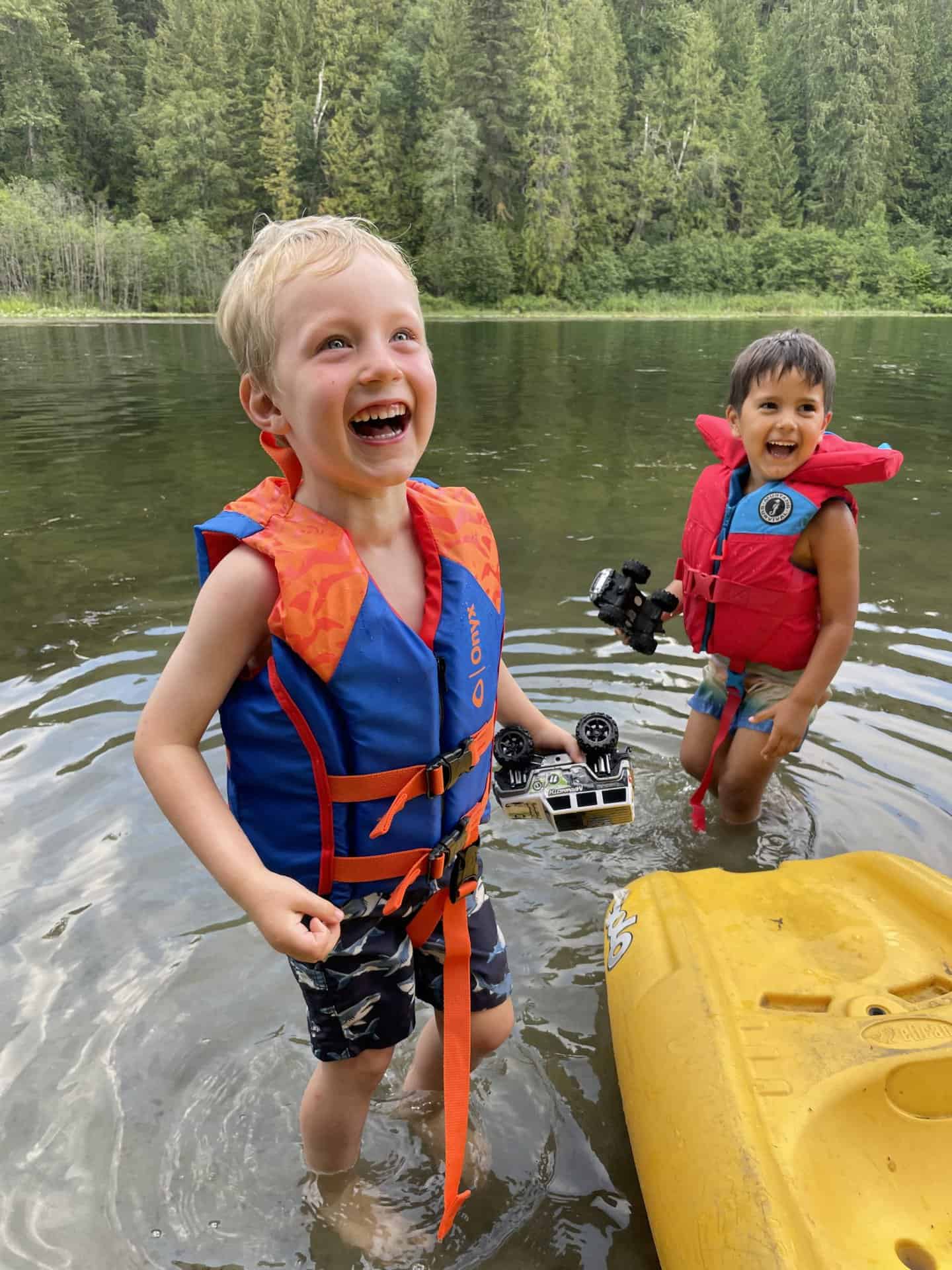 Kids in life jackets paddling