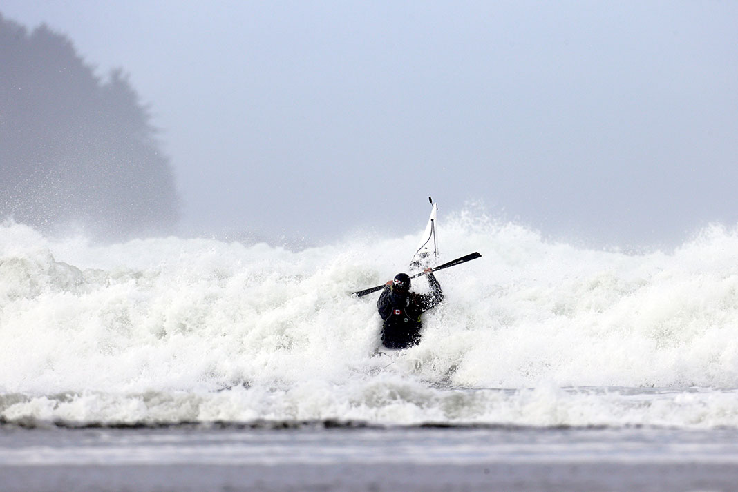 person sea kayaks into roiling surf