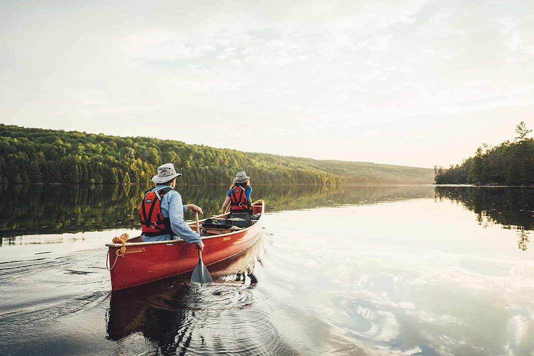 Two people paddling a canoe on a lake