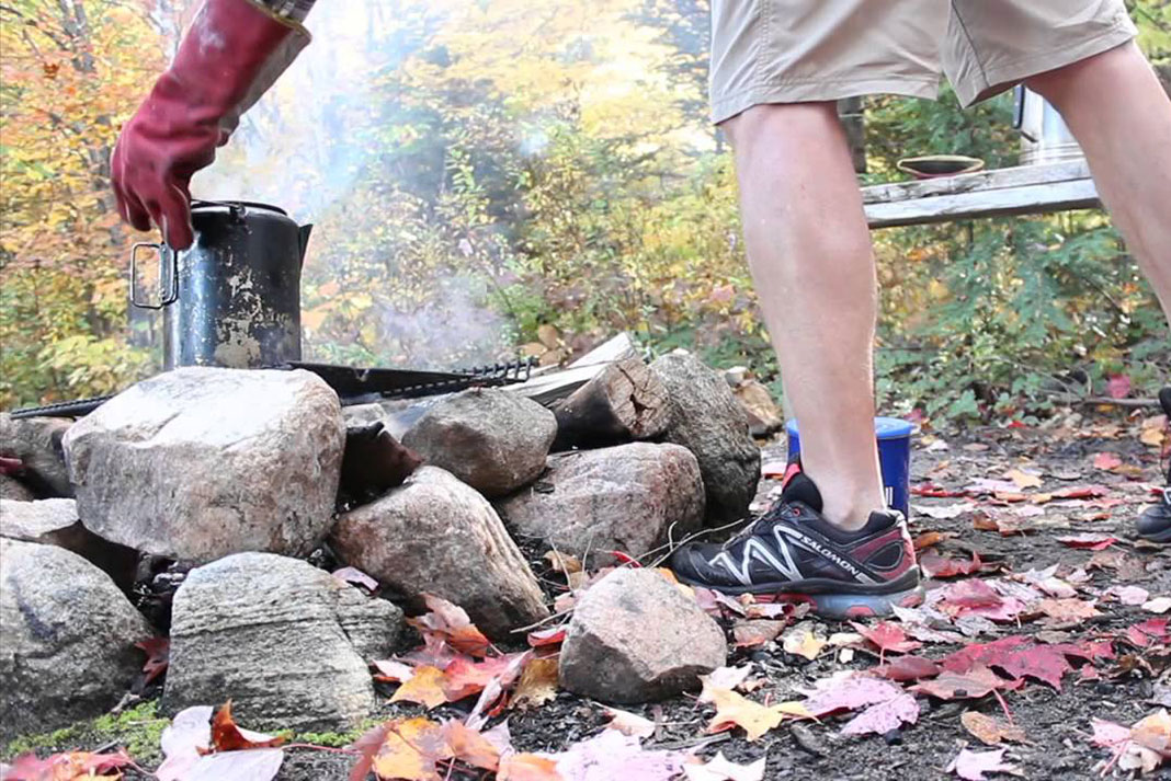 person demonstrates how to makes cowboy coffee at a campsite