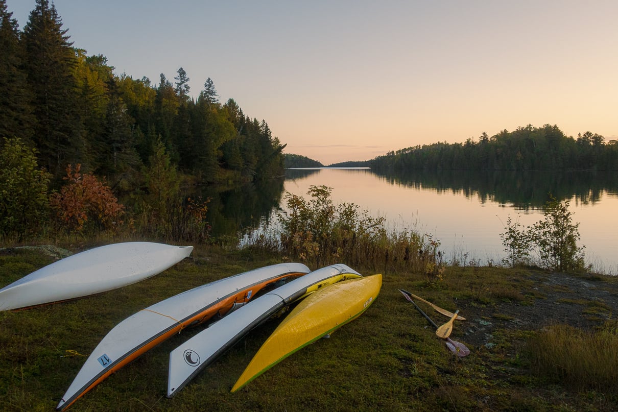 Image of sea kayaks on a shoreline in Michigan; some are registered and others are not