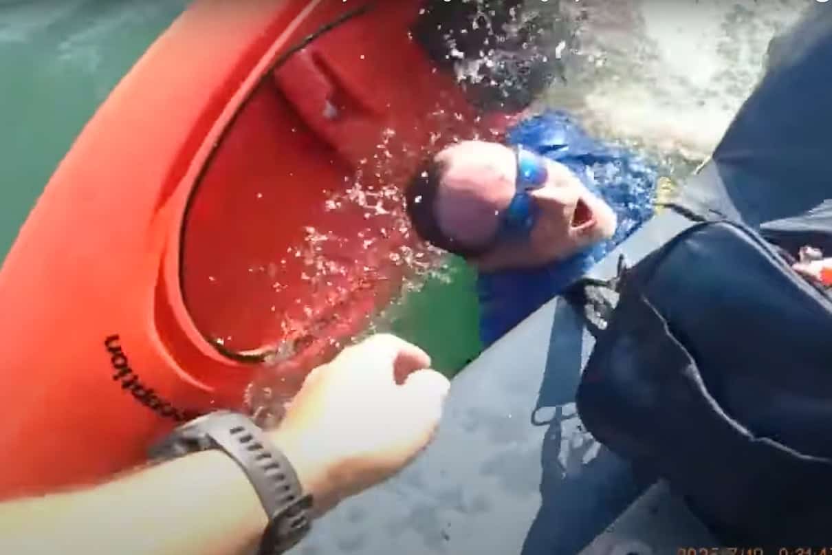FWC officer pulls struggling kayaker from the water in dramatic rescue caught on bodycam footage.