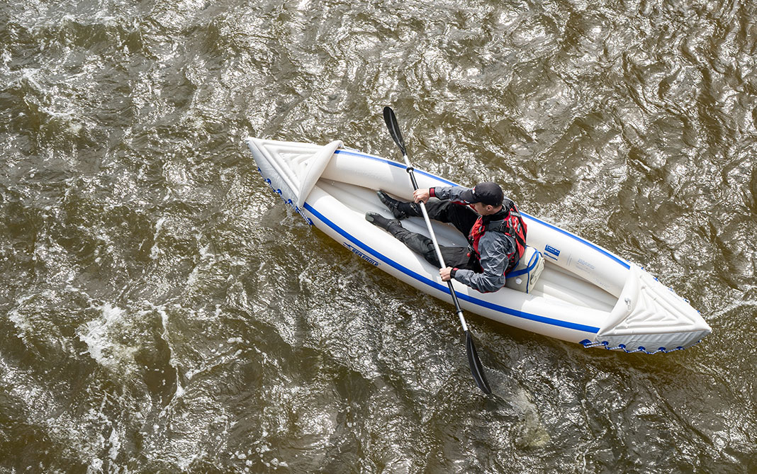 A kayaker takes the Sea Eagle inflatable kayak down a section of river.