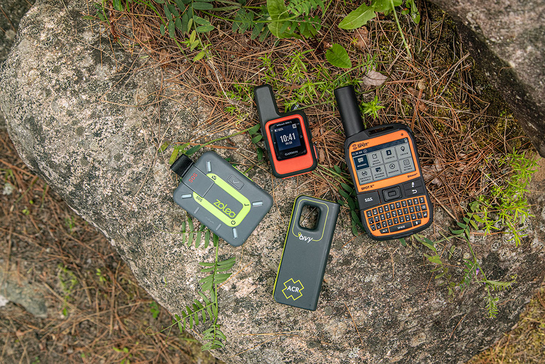 four satellite communicators sit on a rock